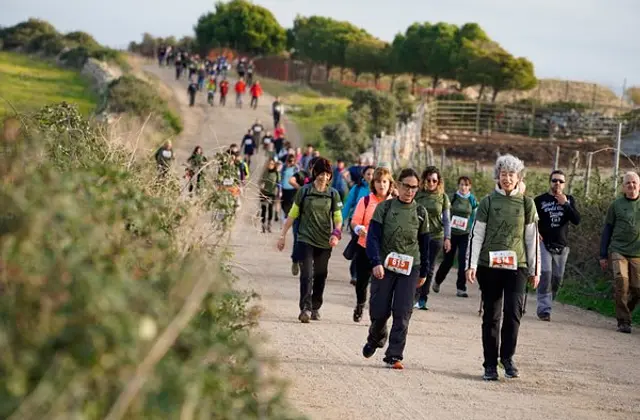 Participants on a dirt track between dry-stone walls
